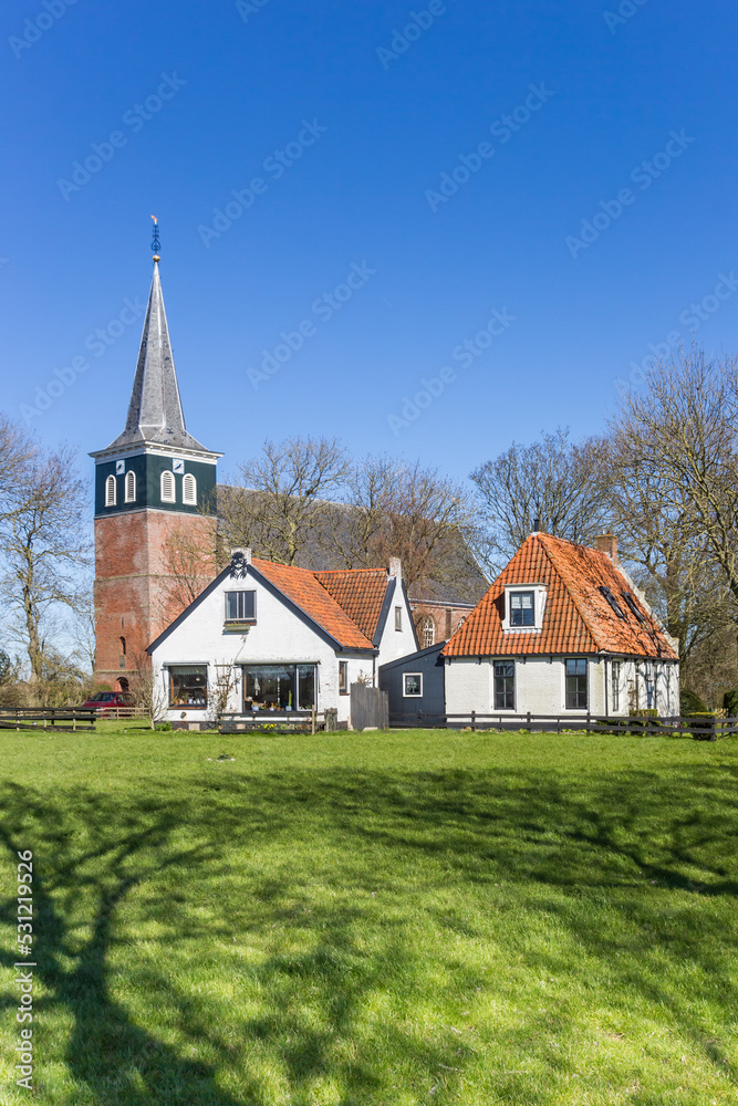Historic church and white houses in Frisian village Makkum, Netherlands Historic church and white houses in Frisian village Makkum, Netherlands