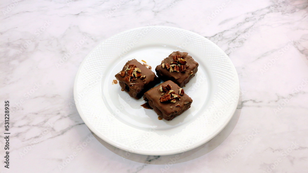 Three pieces of cake with walnut garnish Three pieces of cake with walnut garnish