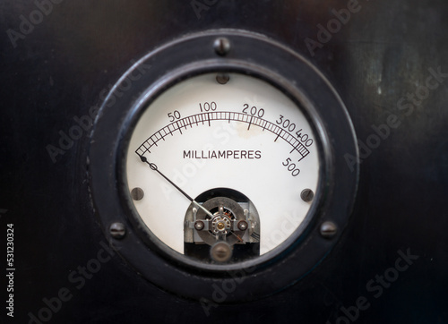 Closeup of a old analog milliammeter for 500 milliampere of direct current, isolated on black.