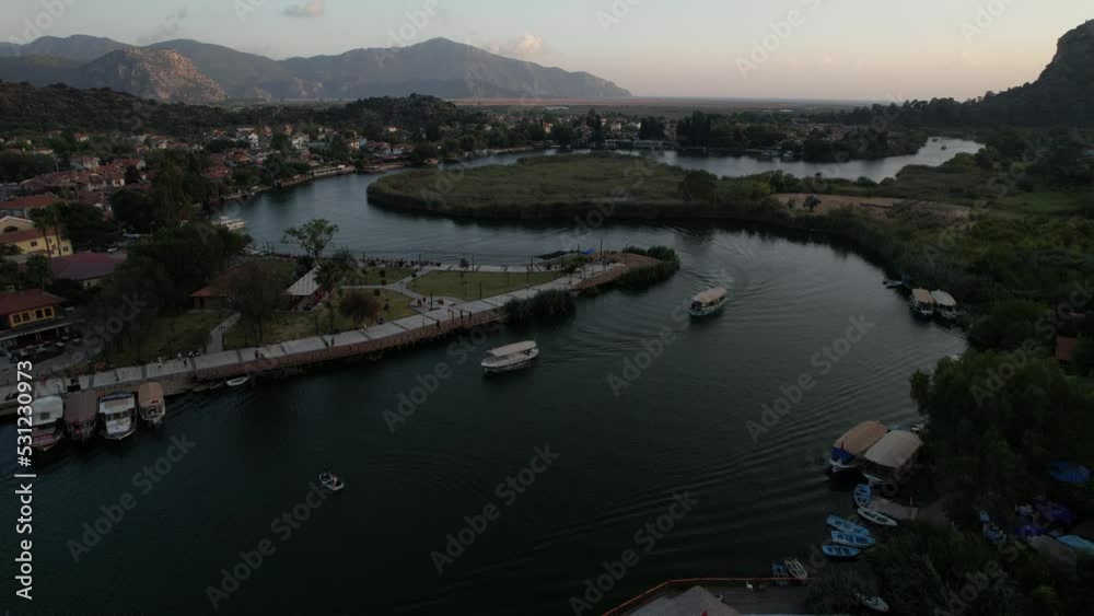 The canal connecting Fethiye lake and iztuzu beach in the Dalyan district of Muğla . Drone footage of excursion boats on the canal - Turkey The canal connecting Fethiye lake and iztuzu beach in the Dalyan district of Muğla . Drone footage of excursion boats on the canal - Turkey