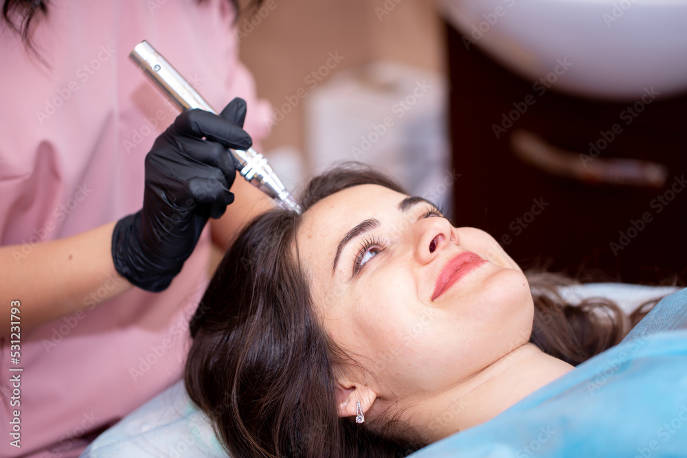 Treatment of the scalp for hair loss, alopecia. A trichologist doctor