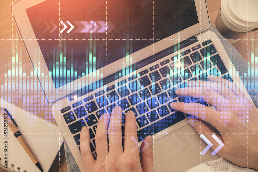 Double exposure of man's hands typing over computer keyboard and forex graph hologram drawing. Top view. Financial markets concept. Double exposure of man's hands typing over computer keyboard and forex graph hologram drawing. Top view. Financial markets concept.