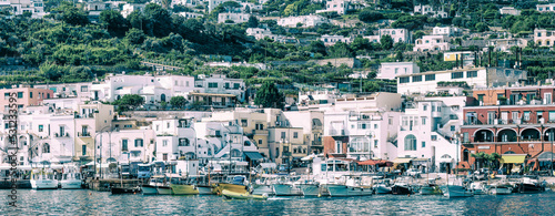 Panoramic view of Capri Island restaurants and shops along the port promenade, Italy
