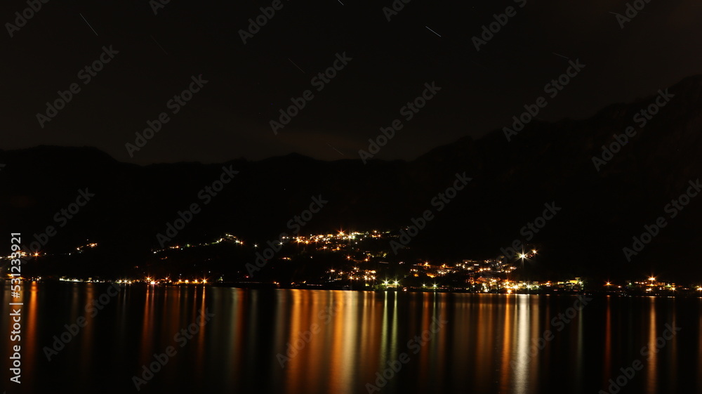 City with a sea and light on the water at night