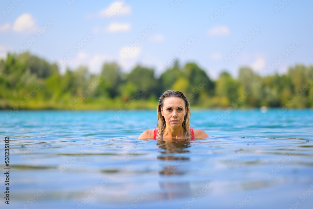 Gorgeous blond woman rising out of the water