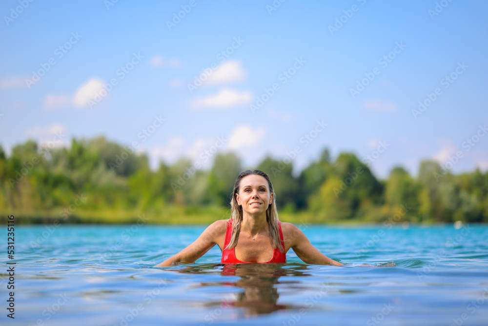 Gorgeous blond woman rising out of the water