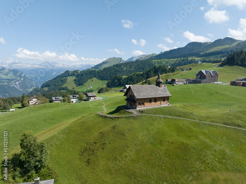 Fronalpstock Klingenstock wooden chapel in Stoos in central Switzerland a small wintersport ski resort village. Grassland alps alpine town on a clear sunny summer day. Clear mountain air and sky. photo