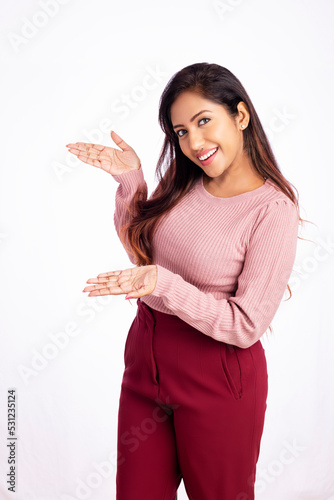 Cheerful young business woman greeting isolated on white.
