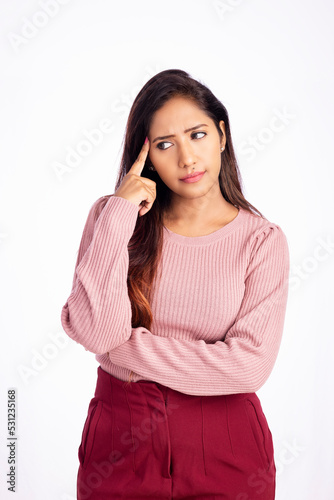 Worried young woman thinking on white background.