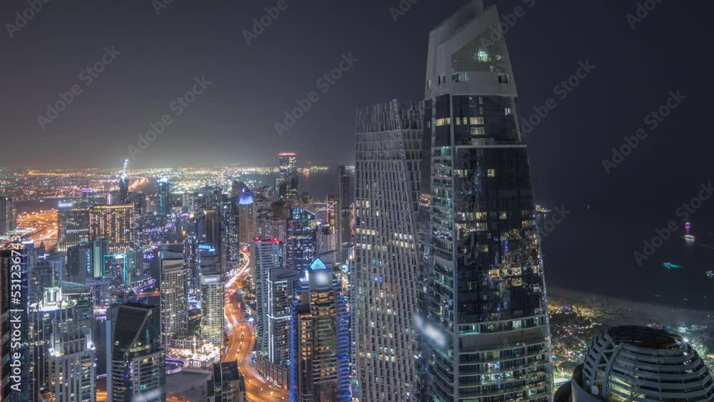 Panorama showing JBR district and Dubai Marina with JLT. Traffic between skyscrapers aerial night timelapse. Panorama showing JBR district and Dubai Marina with JLT. Traffic between skyscrapers aerial night timelapse.