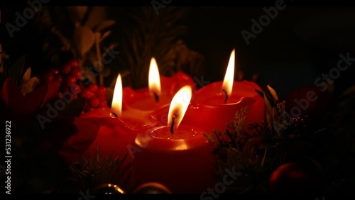 burning candles in the dark. Christmas candles. Light. Gift. Red candle. Figure. Decor.  photo