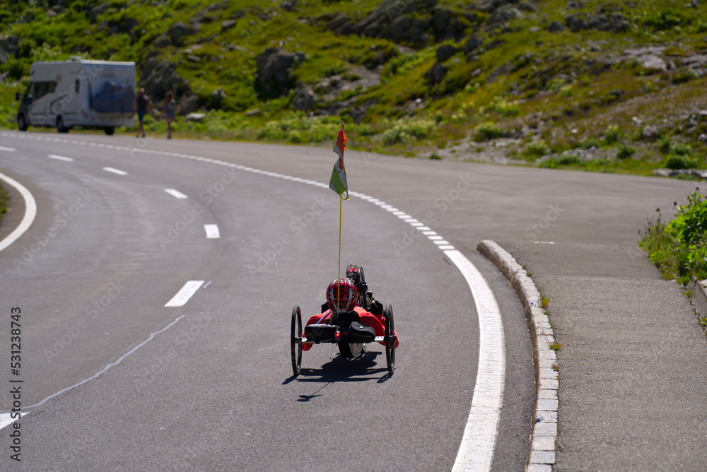 Man on hand bicycle at summit of mountain pass Susten on a sunny summer day. Photo taken July 13th, 2022, Susten Pass, Switzerland. Man on hand bicycle at summit of mountain pass Susten on a sunny summer day. Photo taken July 13th, 2022, Susten Pass, Switzerland.