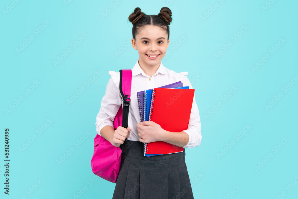 Schoolchild, teenage student girl hold book on blue isolated studio background. School and education concept. Back to school. Happy teenager, positive and smiling emotions of teen girl. Schoolchild, teenage student girl hold book on blue isolated studio background. School and education concept. Back to school. Happy teenager, positive and smiling emotions of teen girl.