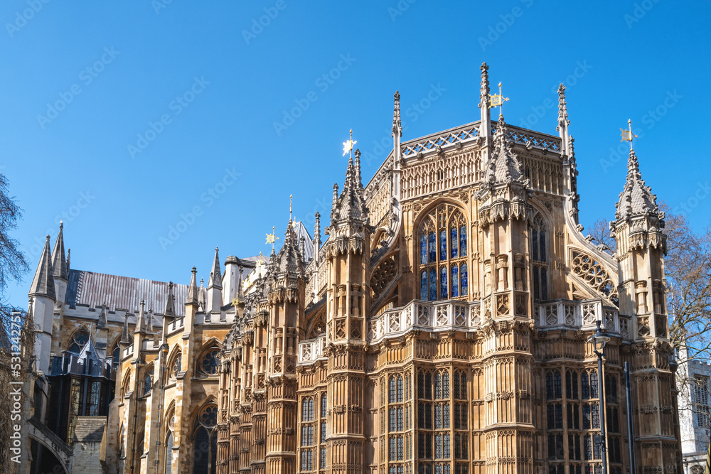 Westminster Abbey, London, famous as the site of many Royal weddings, coronations and burials. Detail of this medieval building against blue sky background.