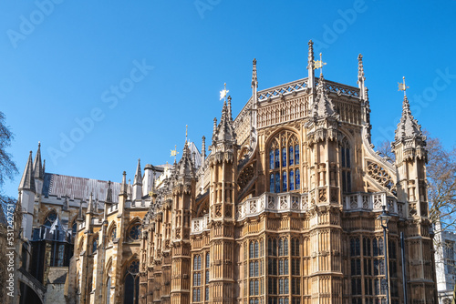 Westminster Abbey, London, famous as the site of many Royal weddings, coronations and burials. Detail of this medieval building against blue sky background.