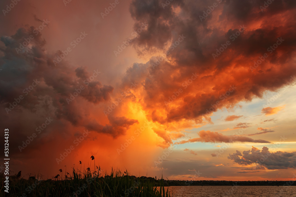Sunset over the lake during the rain Sunset over the lake during the rain