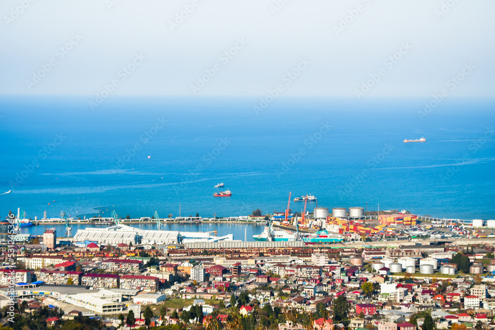 Batumi, Georgia - 25th november, 2021: Aerial wide freight transportation in Batumi Railway view with port panorama and waterfront with blue black sea background