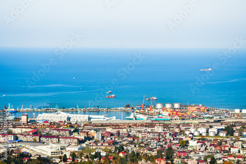 Batumi, Georgia - 25th november, 2021: Aerial wide freight transportation in Batumi Railway view with port panorama and waterfront with blue black sea background