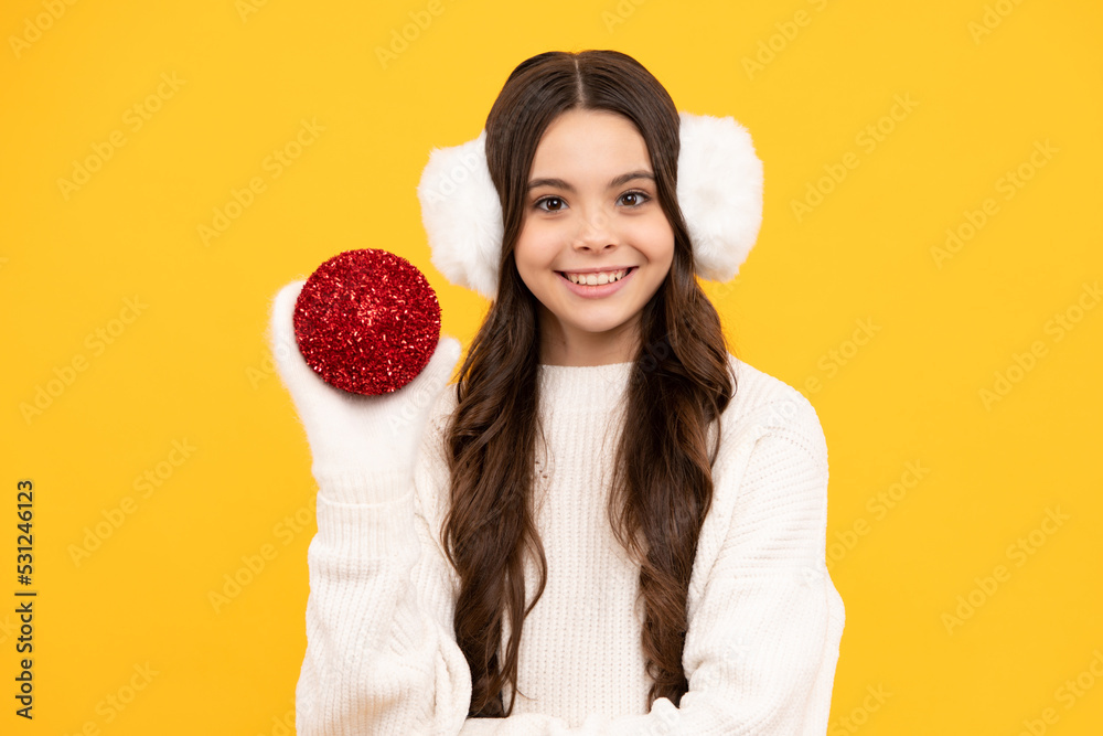 Teenager child santa girl in fur sweater, christmas ball isolated on yellow background. Happy New Year, celebration holiday concept. Teenager child santa girl in fur sweater, christmas ball isolated on yellow background. Happy New Year, celebration holiday concept.