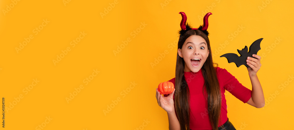 celebrate autumn party holiday. childhood fun. amazed evil child in imp horns hold bat. Halloween kid girl portrait, horizontal poster. Banner header with copy space.