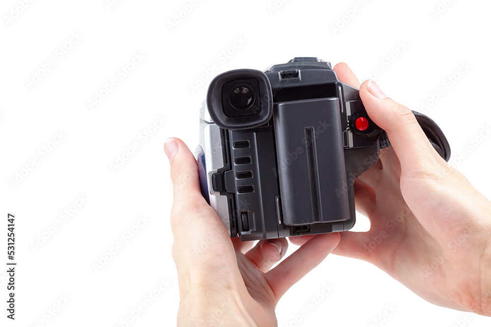 Man holding a simple film camcorder device in hands, old portable movie  camera, first person pov