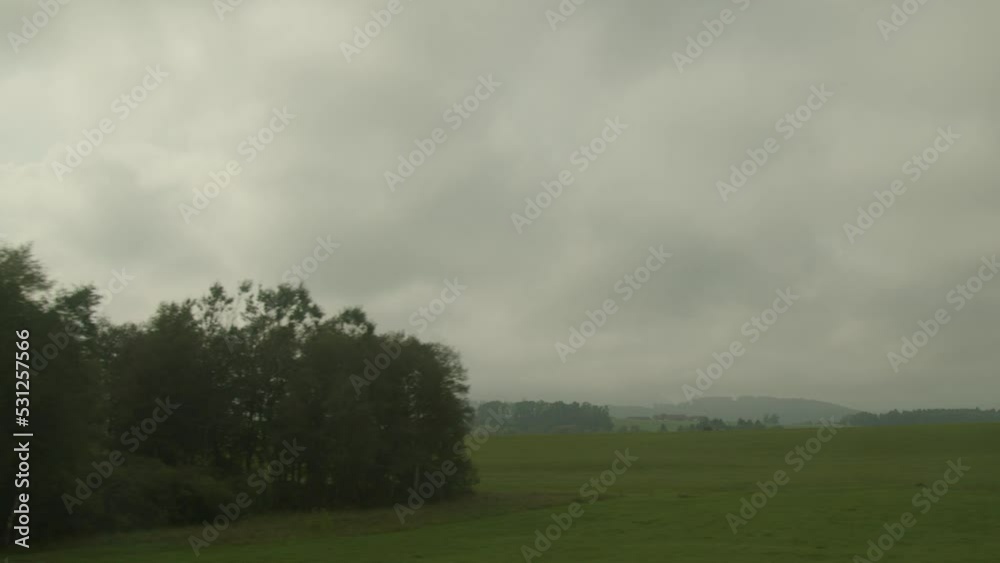 cloudy Salzburg country landscape from driving train cloudy Salzburg country landscape from driving train