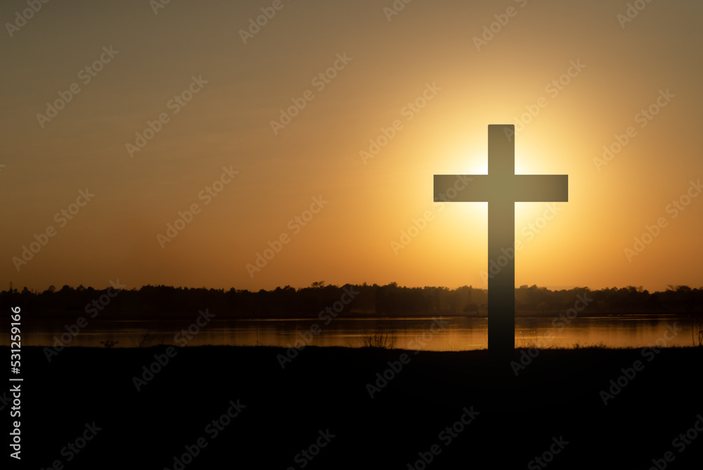 The cross of God in the rays of the sunset