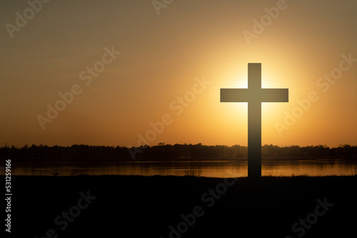 The cross of God in the rays of the sunset