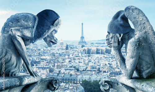 Gargoyles feeling cold, Paris, France. Energy crisis concept.
