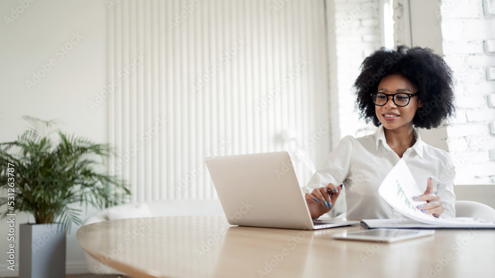 A female secretary working on a project online uses a laptop. A female secretary working on a project online uses a laptop.