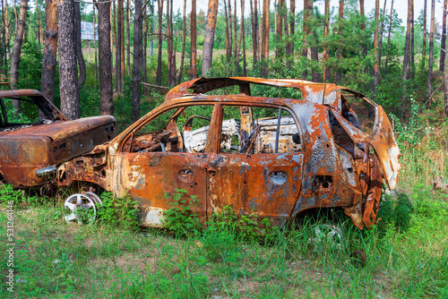 burnt cars. pile of scrap metal. consequences of the war. Irpin, Bucha, Gostomel photo