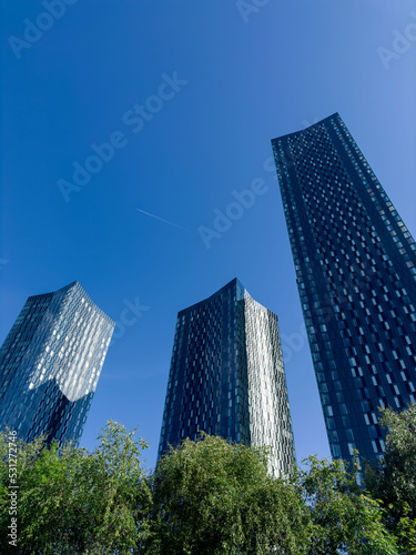 Print op canvas Manchester City Centre Modern skyscrapers with a blue sky background Building Wo