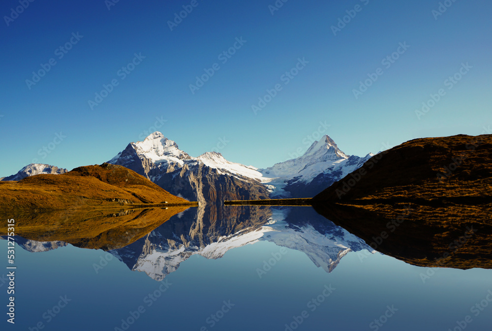 Spectacular panoramic views of high peaks reflected above Lake Bachalpsee, Switzerland, Grindelwald.