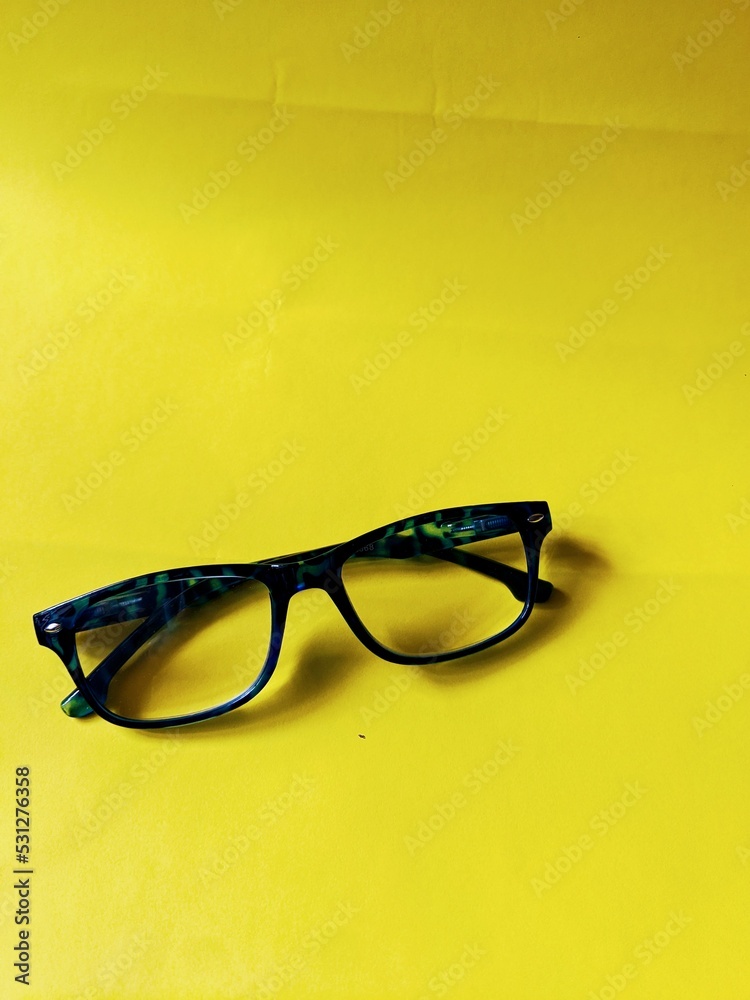 GLASSES WITH BLACK FRAME WITH YELLOW COLOR GLASSES WITH BLACK FRAME WITH YELLOW COLOR