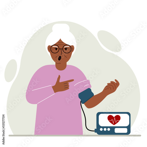 Old woman checks blood pressure. healthcare concept. Blood pressure measurement, digital tonometer. Health monitoring.