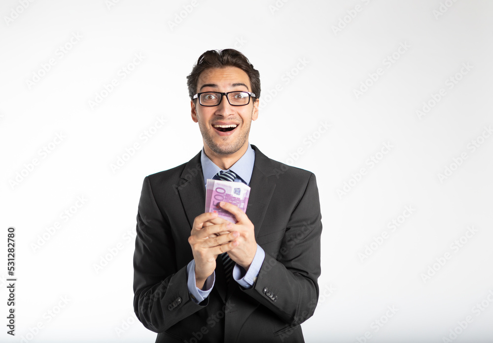 Happy businessman holding pack of cash money isolated on white background Happy businessman holding pack of cash money isolated on white background