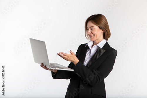 Young attractive and smiling business woman in black suit holding laptop isolated on white. Copy space and place for text concept