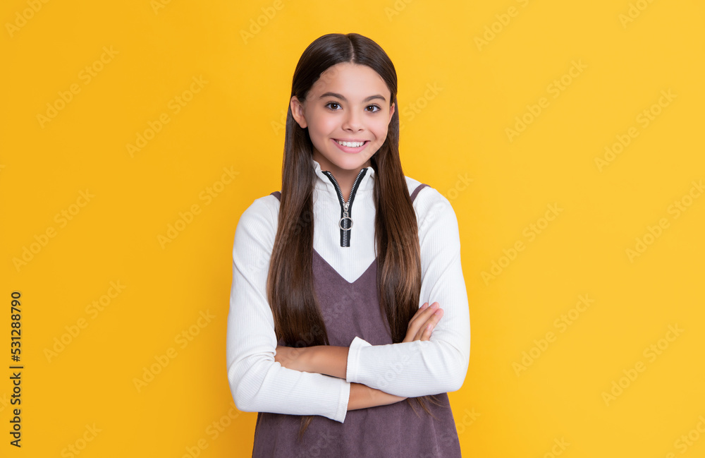 happy child with long hair on yellow background