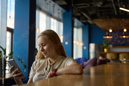 Woman is fascinated by search and watching content on smartphone