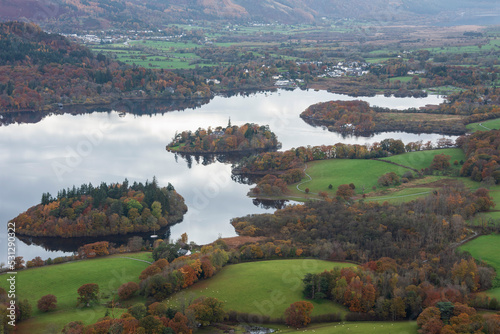 Beautiful landscape Autumn image of view from Walla Crag in Lake District, over Derwentwater looking towards Catbells and distant mountains with stunning Fall colors and light