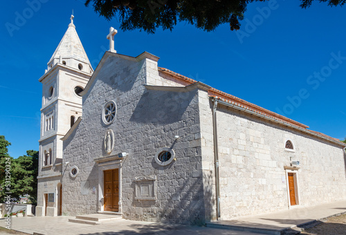 St. George's Church made of white limestone standing atop a mountain on the island. Primosten, Croatia.