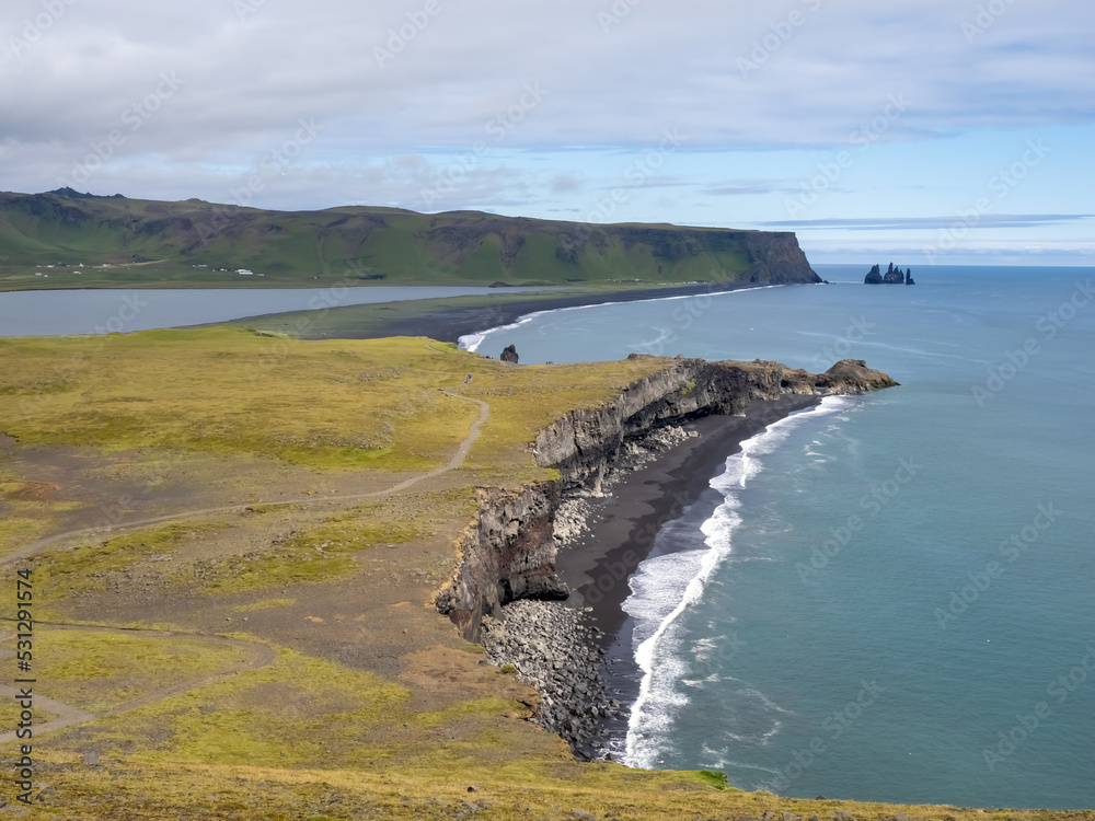 The iconic black sand beaches of Reynisfjara and the sea stacks ...