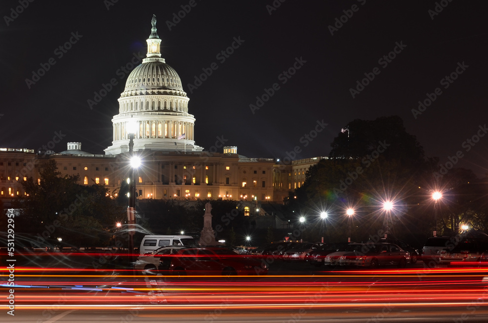 Car lights trails and US Capitol building at night - Washington DC, United States