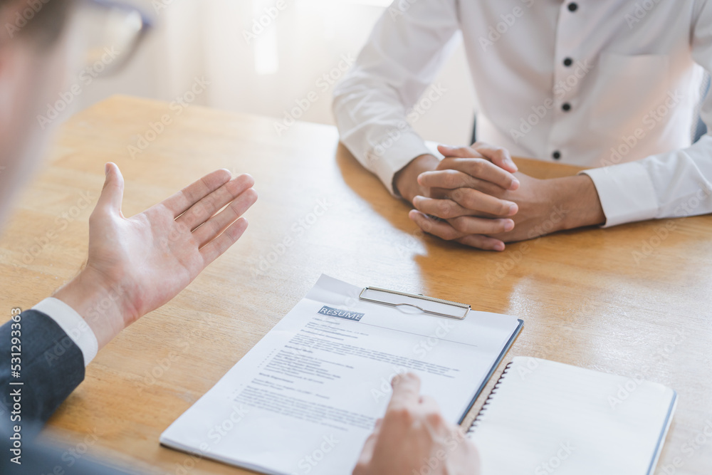 Asian young manager, employer man interview with person, have question about resume and listen to candidate answer, conversation together at office. Recruitment employee job concept. Asian young manager, employer man interview with person, have question about resume and listen to candidate answer, conversation together at office. Recruitment employee job concept.