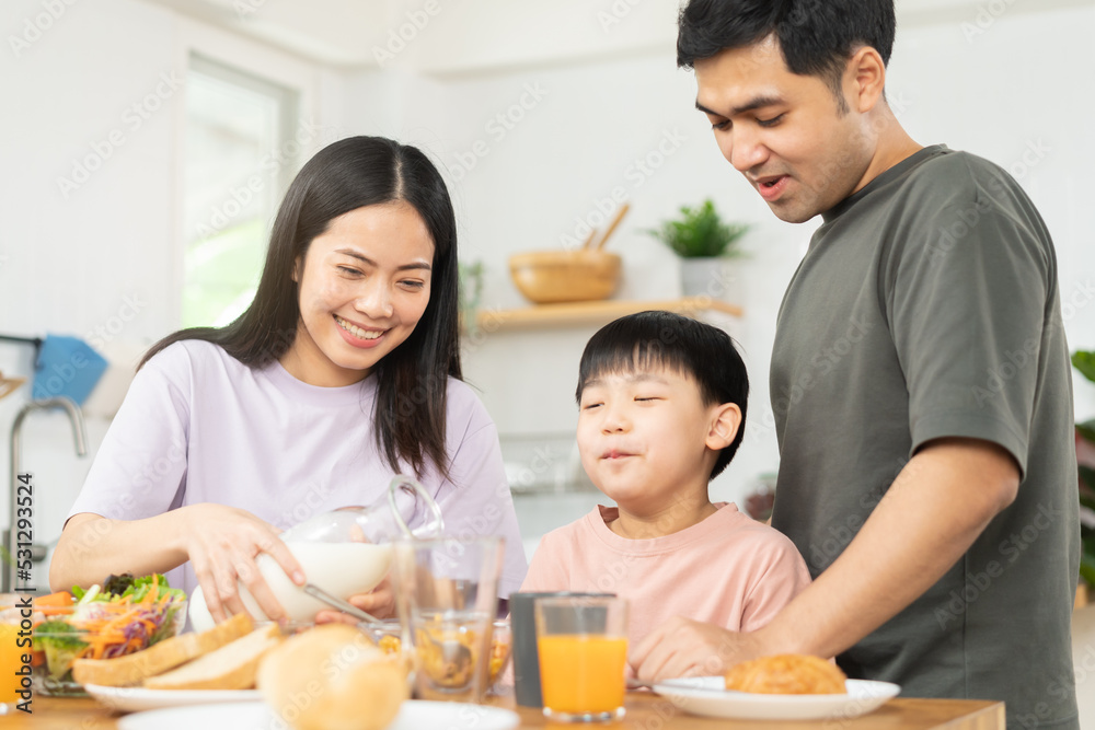 Happy refreshment family breakfast in morning, asian young parent father, mother and little cute boy, child having meal in kitchen eating together at home. Cheerful, enjoy cooking people. Happy refreshment family breakfast in morning, asian young parent father, mother and little cute boy, child having meal in kitchen eating together at home. Cheerful, enjoy cooking people.