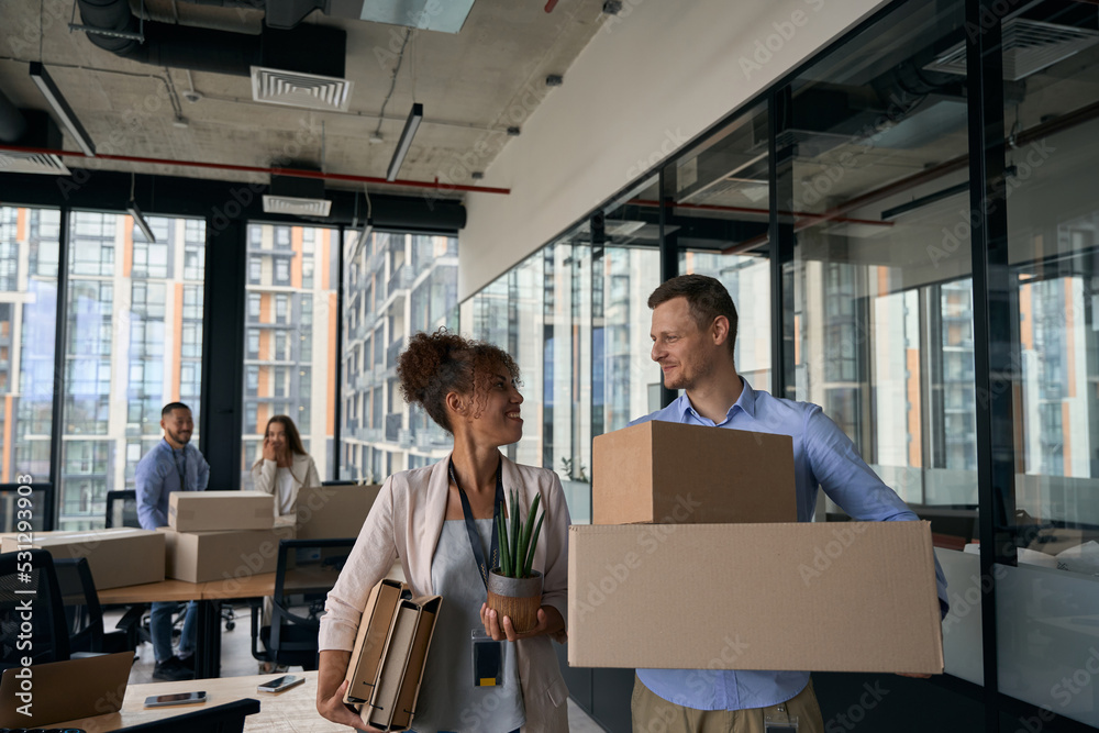 Fototapeta premium Happy corporate workers preparing for office relocation