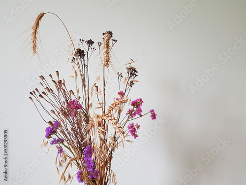 bouquet of wheat with wild flowers on a light background wallpaper