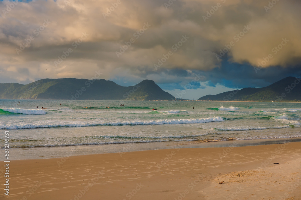 Morro das Pedras beach and ocean with waves at sunrise