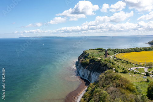 Obraz na płótnie The island Ruegen Germany with many rape fields and lighthouse w salonie