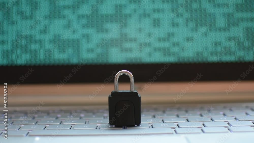 Locked metal padlock on a laptop keyboard over blue background. Cyber security, antivirus software concept